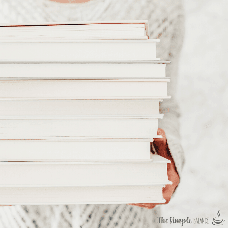 Cozy moment with a stack of pristine books, inviting relaxation and intellectual exploration.