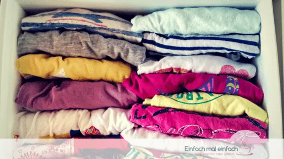 Simple space-saving hacks 6 Colorful kids shirts foldet and stacked like CDs in a drawer organizer.
