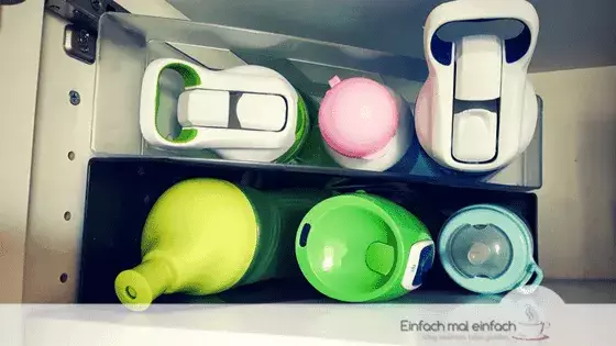 Simple space-saving hacks 5 Several water bottles arranged in magazine folders.