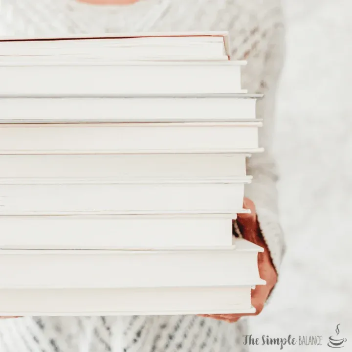 Cozy moment with a stack of pristine books, inviting relaxation and intellectual exploration.