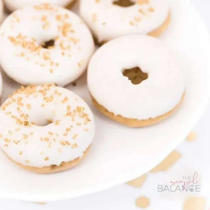 Elegant white iced donuts with golden sprinkles celebrate indulgence and joy. Perfect for any occasion!