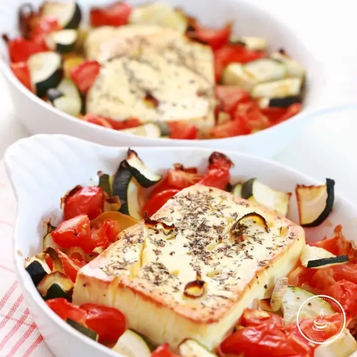 Baked vegetables with golden cheese, fresh herbs, and vibrant colors for a delicious shared dish.