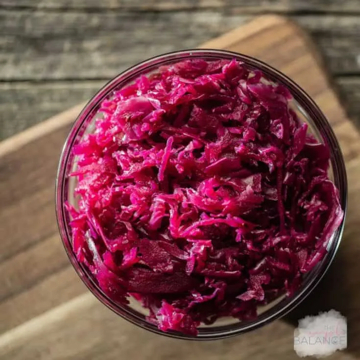 Bright, finely shredded red cabbage in a clear bowl, perfect for salads and garnishes.