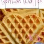 Fluffy heart-shaped German waffles, golden brown with intricate patterns, perfect for a warm treat.
