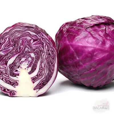 Vibrant purple cabbage showcasing intricate layers and fresh, glossy texture for healthy culinary dishes.