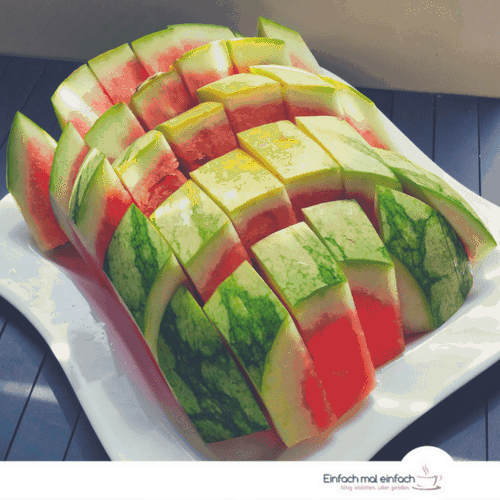 6 Food Prep Tips To Save Time & Money 2 Watermelon cut in sticks on white square plate and dark wooden ground.