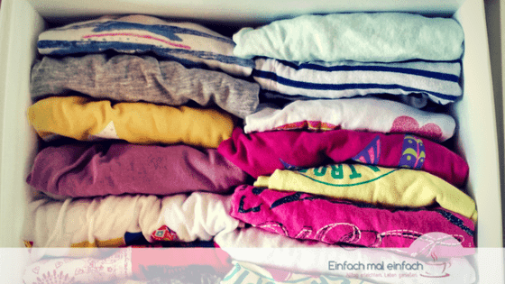 Simple space-saving hacks 6 Colorful kids shirts foldet and stacked like CDs in a drawer organizer.
