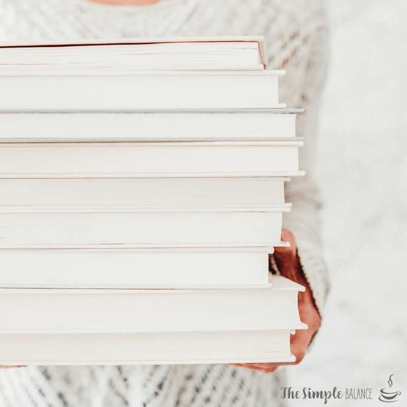 Cozy moment with a stack of pristine books, inviting relaxation and intellectual exploration.